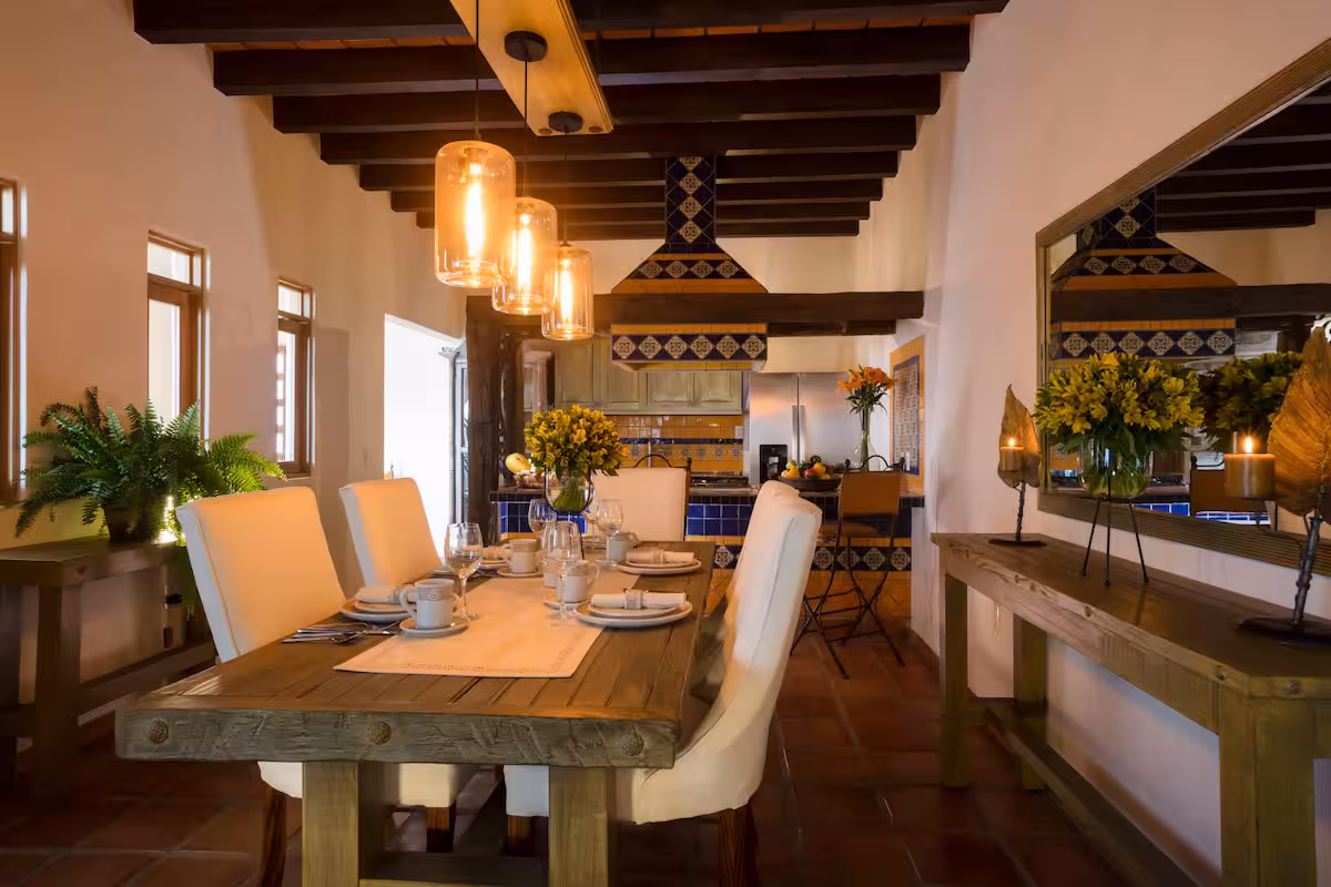 Long dining table beneath exposed wooden beams