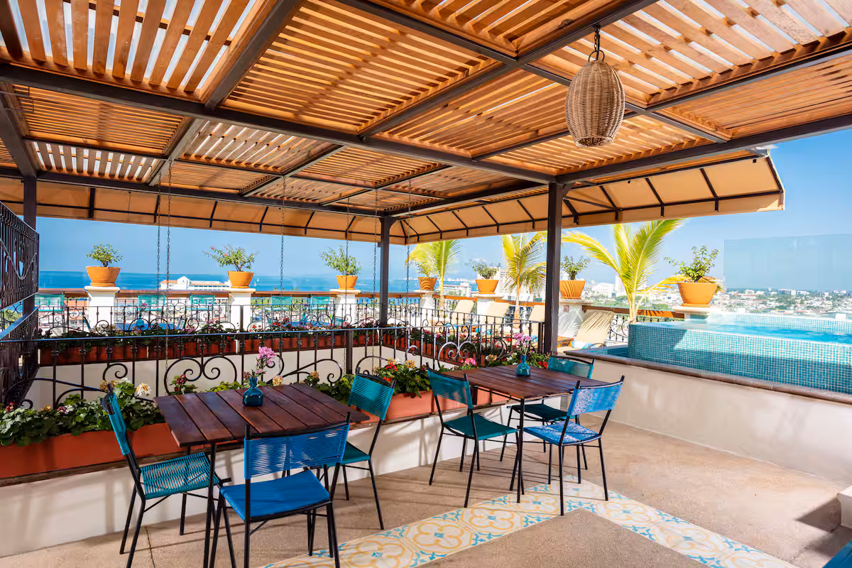 Covered rooftop seating beside the pool