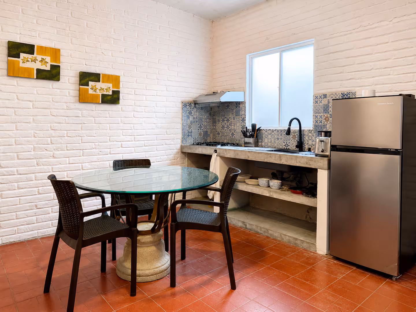 Dining table and kitchen with tiled backsplash
